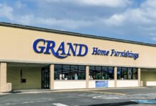 alt="Grand Home Furnishings store exterior with large sign and parking lot"